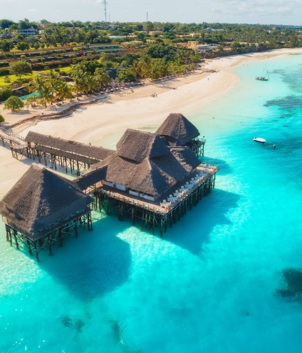 Aerial view of beautiful hotel on the water in ocean at sunset