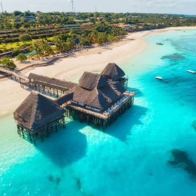 Aerial view of beautiful hotel on the water in ocean at sunset