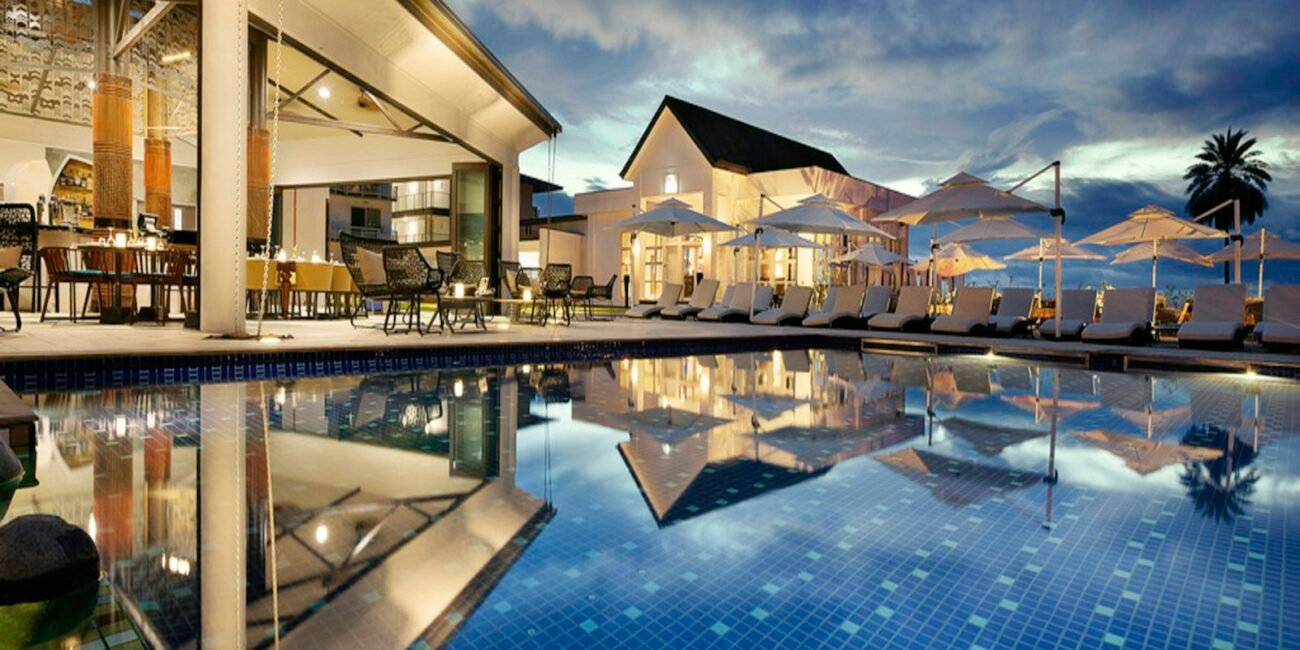 Resort pool umbrellas beside the sea