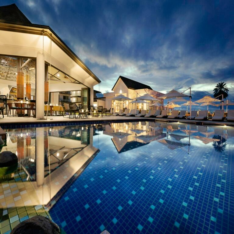 Resort pool umbrellas beside the sea